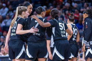 Aces players come together on a timeout against the Phoenix Mercury during the first half of th ...