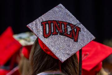 A graduate wears a custom mortar board during UNLV spring graduation commencement exercises at ...