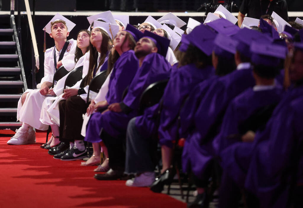 Durango High School students watch a slide show during graduation at Thomas & Mack Center o ...