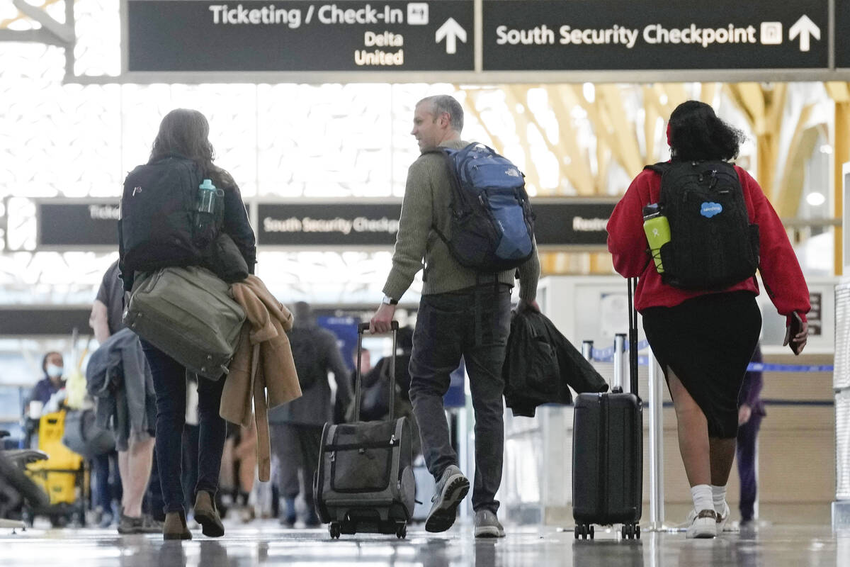 People walk through Reagan Washington National Airport in Arlington, Va., Wednesday, Nov. 22, 2 ...