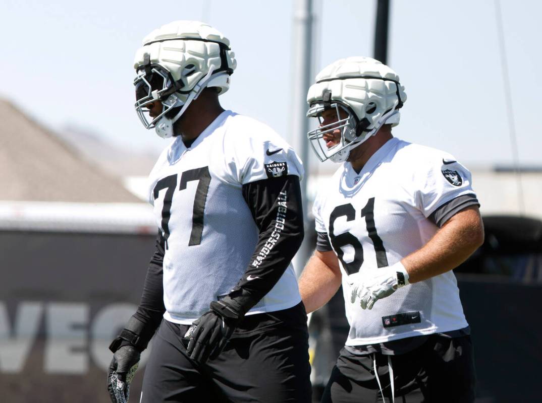 Raiders offensive tackle Thayer Munford Jr. (77) and guard Jordan Meredith (61) take the field ...