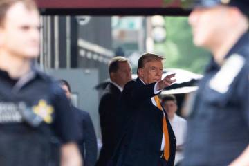 Former president Donald Trump waves while leaving Trump Tower on his way to Manhattan criminal ...