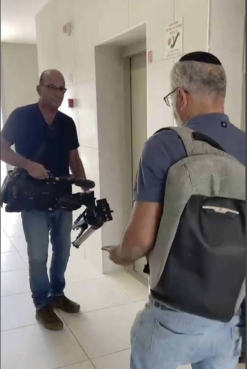 In this image from video, Israeli officials seize AP video equipment from an apartment block in ...