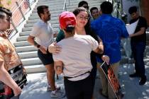 Zena Hajji, who was in the Student Union during the UNLV shooting, facing, gets a hug after a p ...