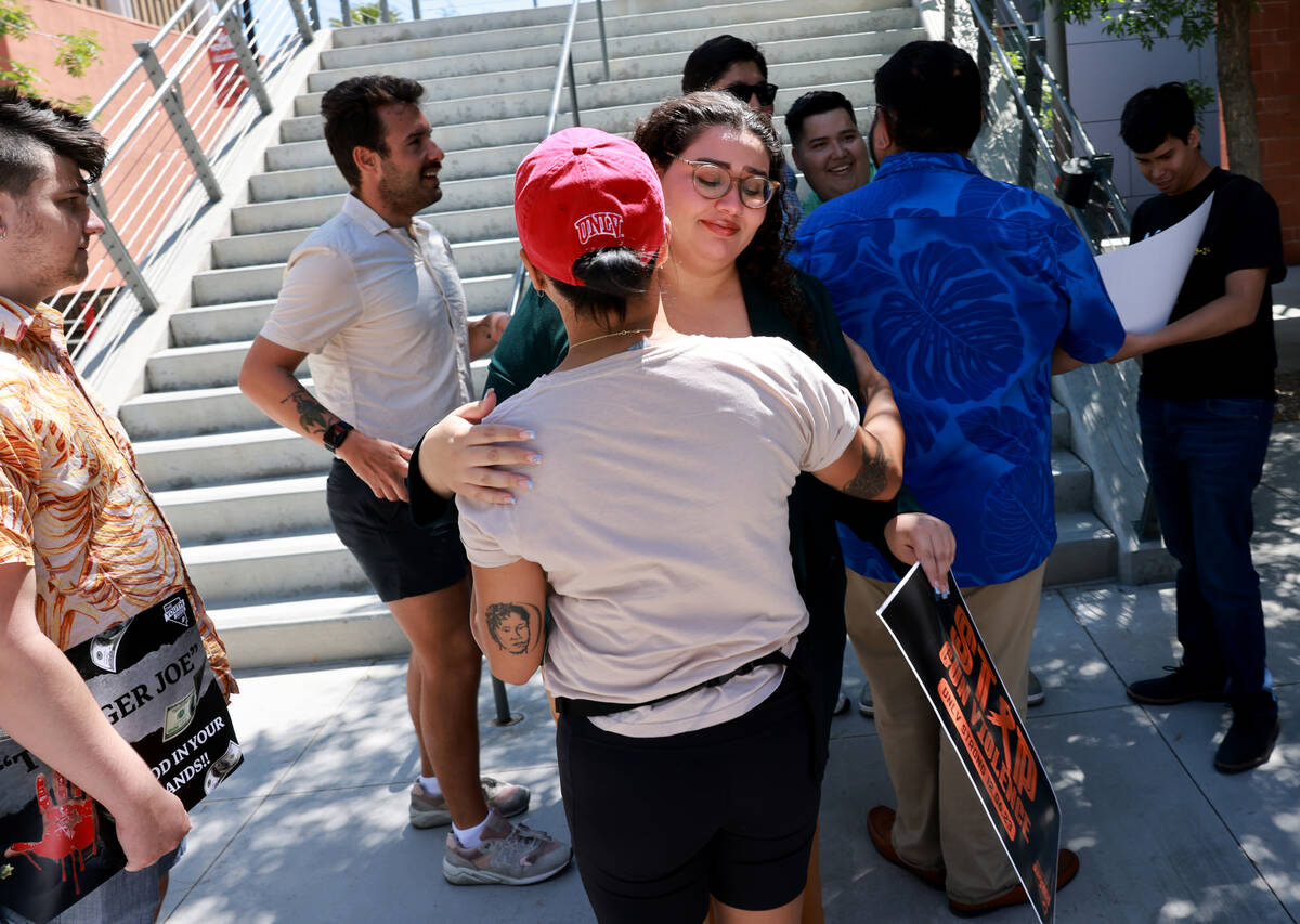 Zena Hajji, who was in the Student Union during the UNLV shooting, facing, gets a hug after a p ...