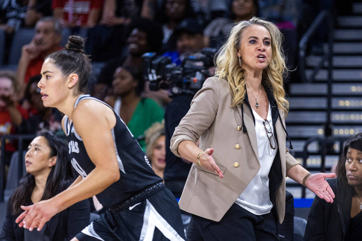Las Vegas Aces guard kelsey Plum heads up court while head coach Becky Hammon directs others du ...