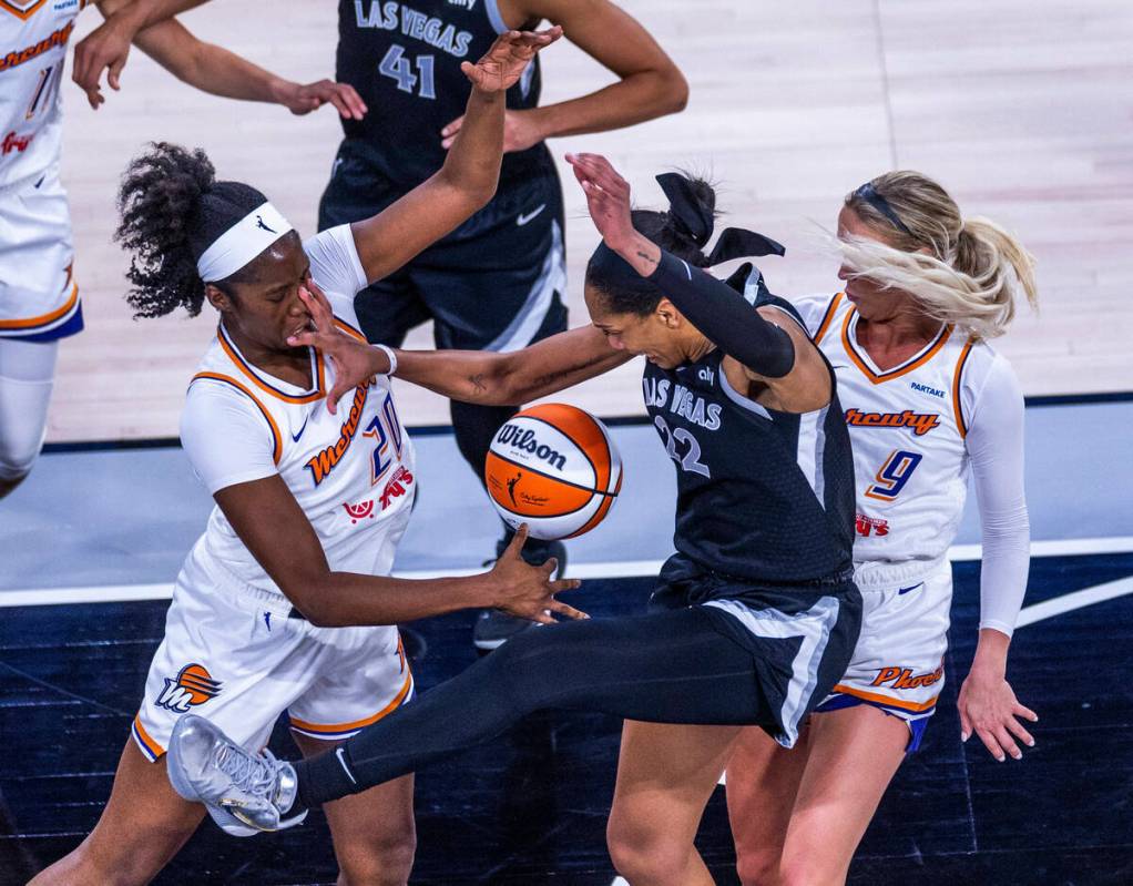 Phoenix Mercury forward Liz Dixon (20) takes a hand to the face from Aces center A'ja Wilson (2 ...