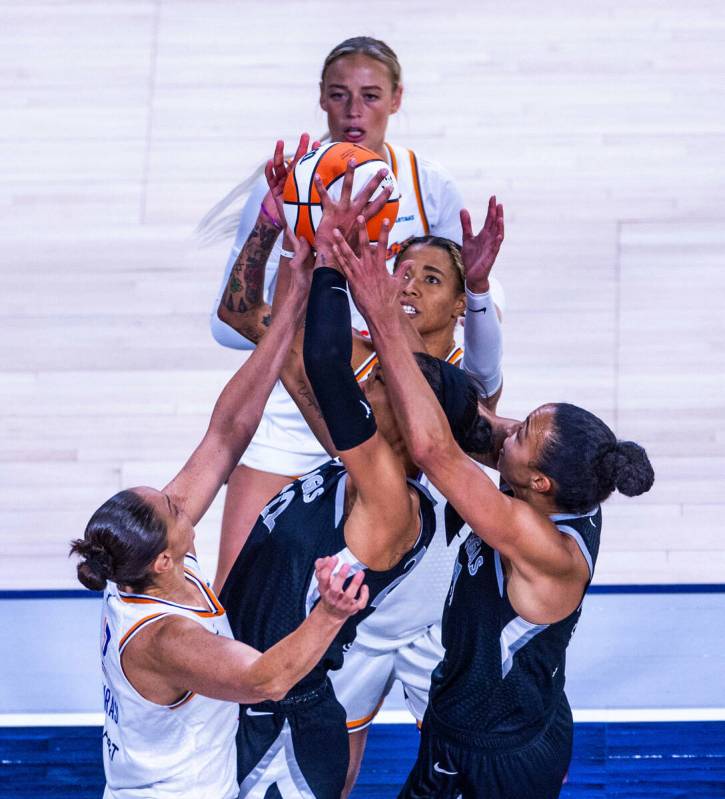 Aces center A'ja Wilson (22) attempts to pull down a rebound over Phoenix Mercury guard Diana T ...