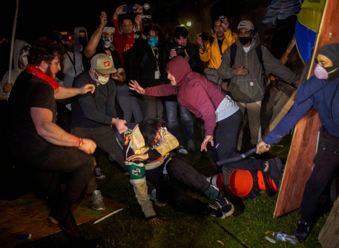 FILE - Demonstrators clash at an encampment at UCLA early Wednesday, May 1, 2024, in Los Angele ...