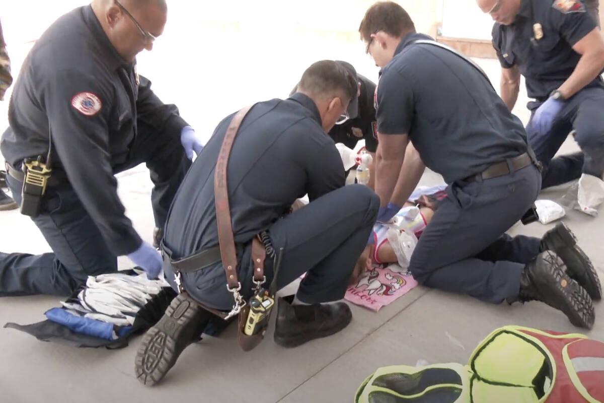 Members of the Henderson Fire Department conduct a mock drowning drill as part of a water safet ...