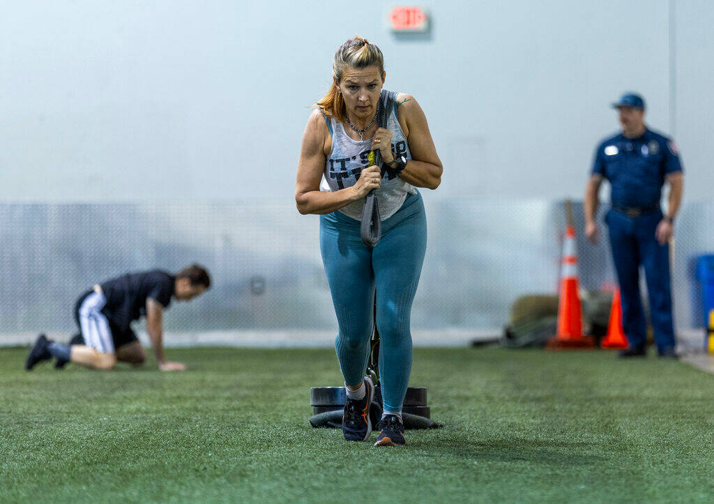 A participant drags a weighted sleigh during the Las Vegas Fire & Rescue free community boo ...