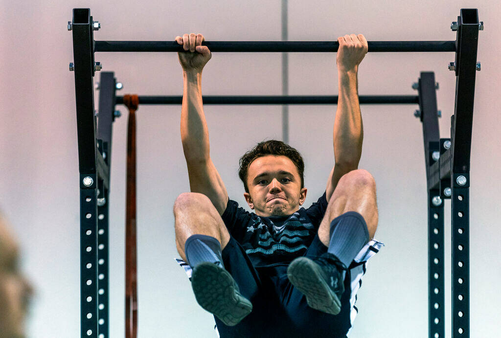 Participant Keani Borcherdt, 20, pulls up while hanging from a bar during the Las Vegas Fire &a ...