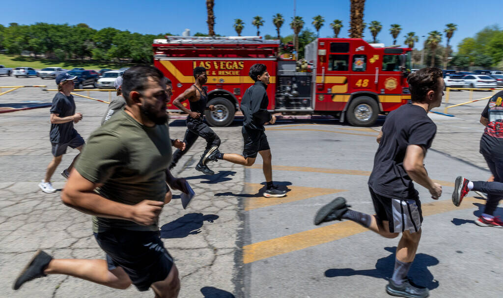 Participants complete a 1 1/2 mile run during the Las Vegas Fire & Rescue free community bo ...