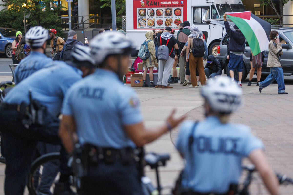 Police stand by as protestors prepare to leave a pro-Palestinian encampment at Drexel Universit ...