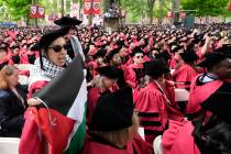 Graduating students chant as they depart commencement in protest to the 13 graduating seniors w ...