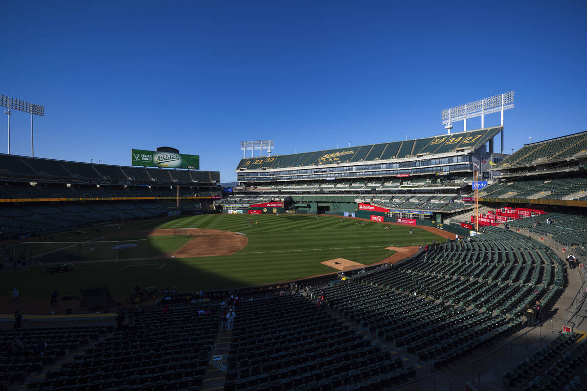 Fans walk to their seats before the start of a baseball game, April 2, 2024, in Oakland, Calif. ...