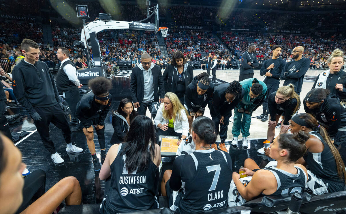 Aces head coach Becky Hammond talks with her team on a timeout versus the Phoenix Mercury durin ...