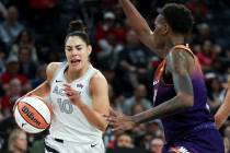 Las Vegas Aces guard Kelsey Plum (10) drives toward the hoop against Phoenix Mercury forward Na ...