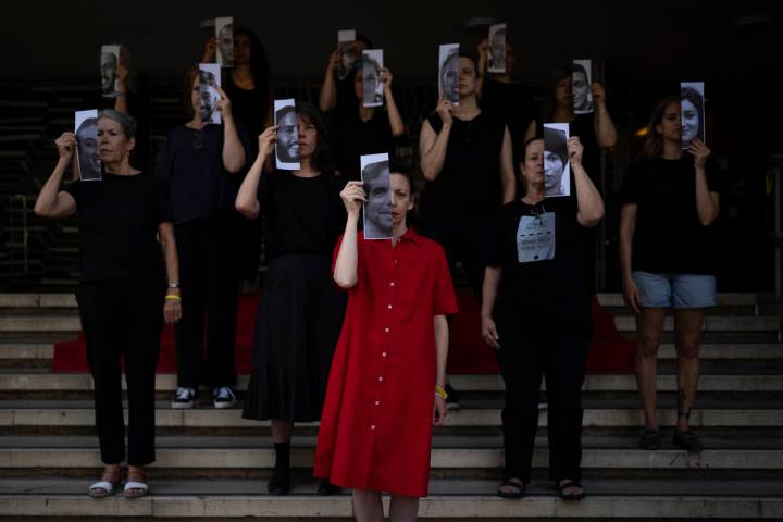 Relatives and supporters of Israeli hostages held by Hamas in Gaza hold photos of their loved o ...