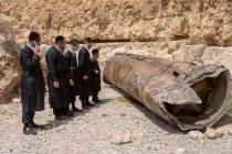 Ultra-Orthodox Jews observe the part of the intercepted ballistic missile that fell in the dese ...