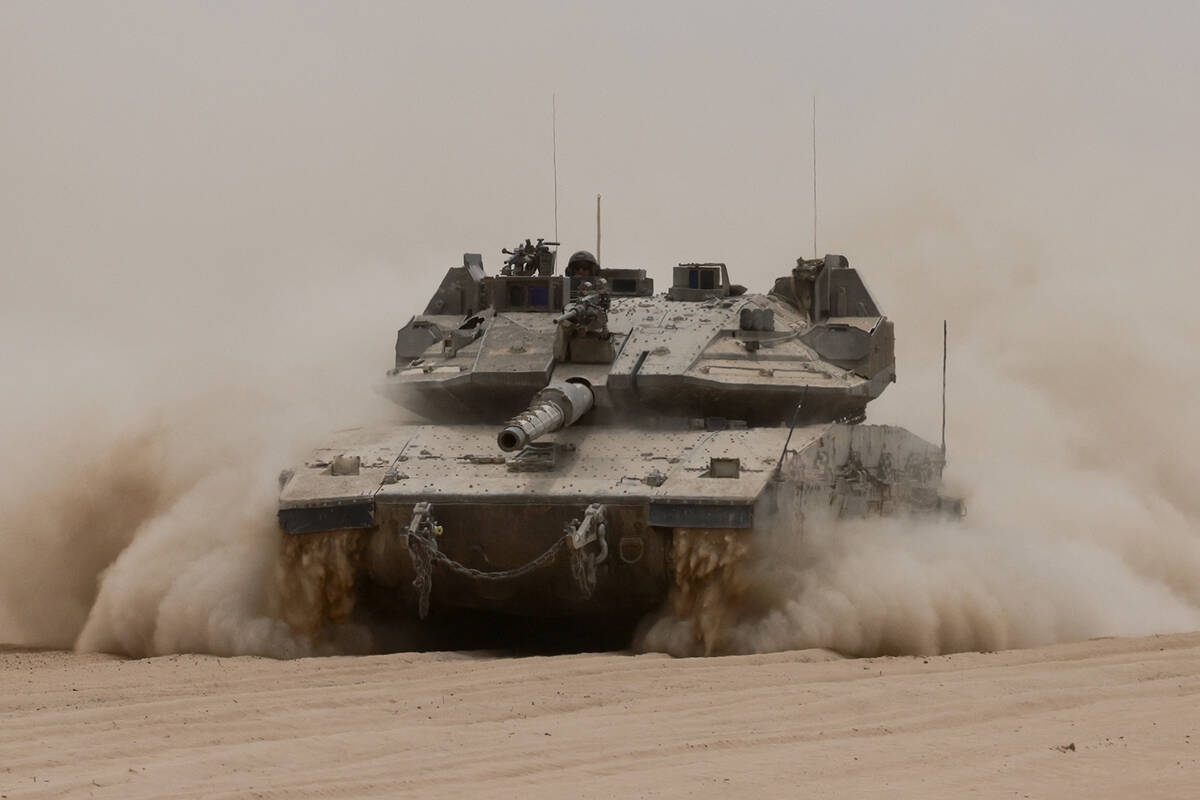 An Israeli army tank rolls along Israel's southern border with the Gaza Strip on Tuesday, May 2 ...