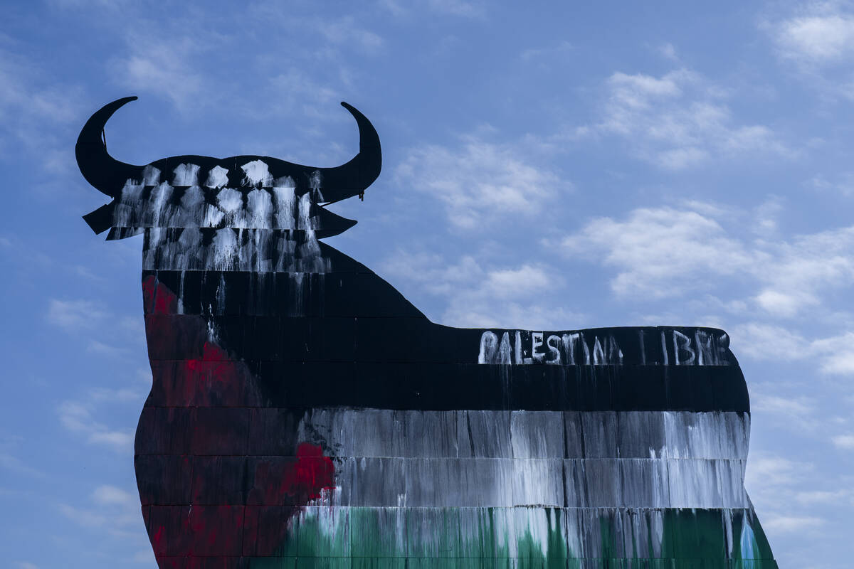 A Spanish fighting bull billboard, is painted with the colours of the Palestinian flag and a wr ...