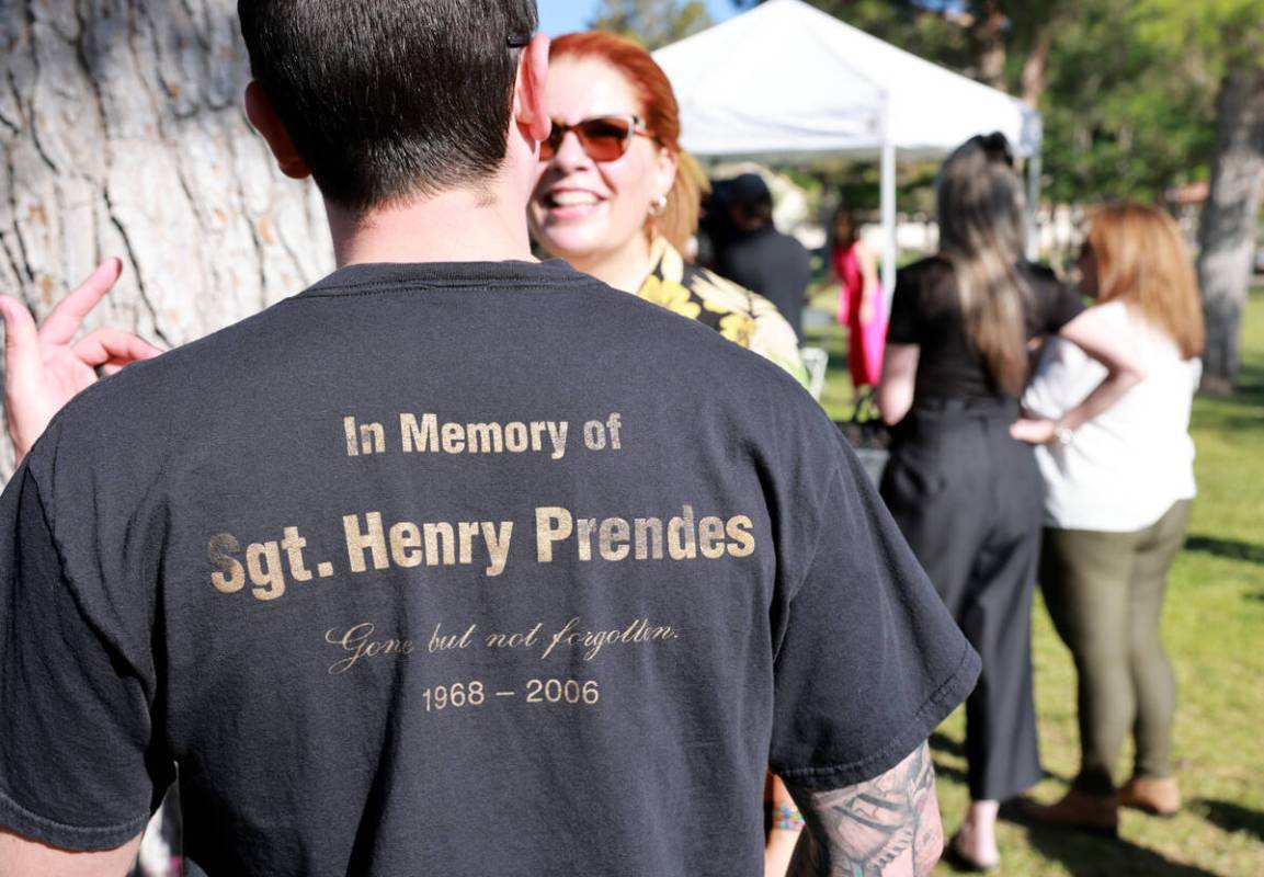 Family and friends mingle during a ceremony to rename a Las Vegas park in the officer’s ...