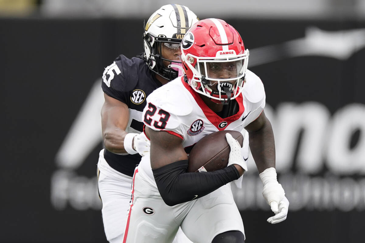 Georgia defensive back Tykee Smith (23) runs the ball after making an interception past Vanderb ...