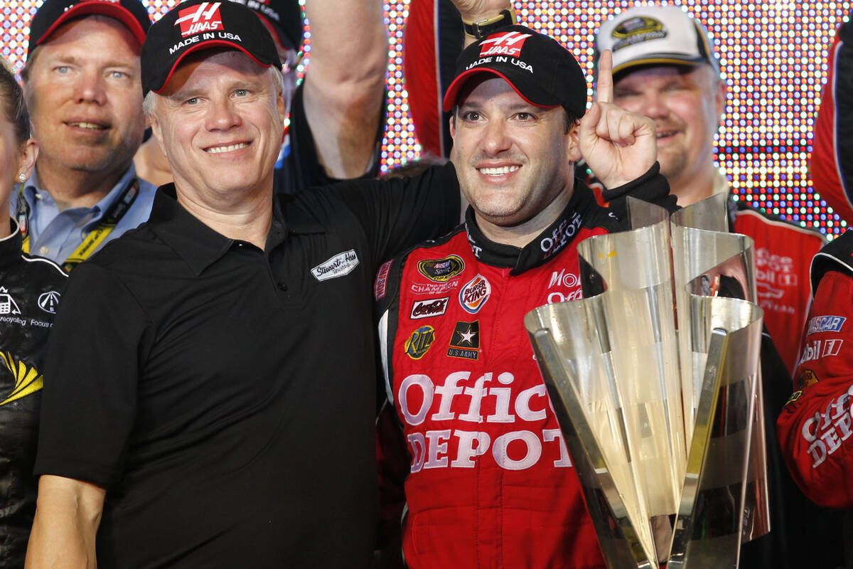 Team co-owner Carl Haas and Tony Stewart, right, pose with the NASCAR Sprint Cup Series season- ...