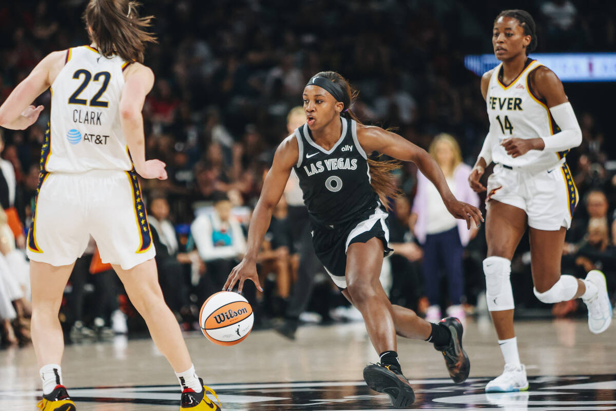 Aces guard Jackie Young (0) drives the ball during a game between the Aces and Indiana Fever at ...