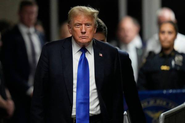 Former President Donald Trump walks to make comments to members of the media after being found ...
