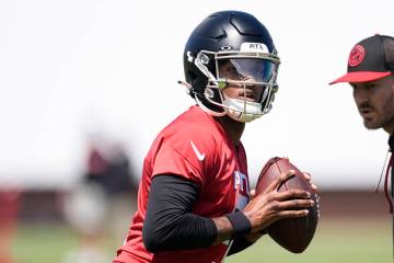 Atlanta Falcons first round draft pick quarterback Michael Penix Jr., runs a passing drill duri ...