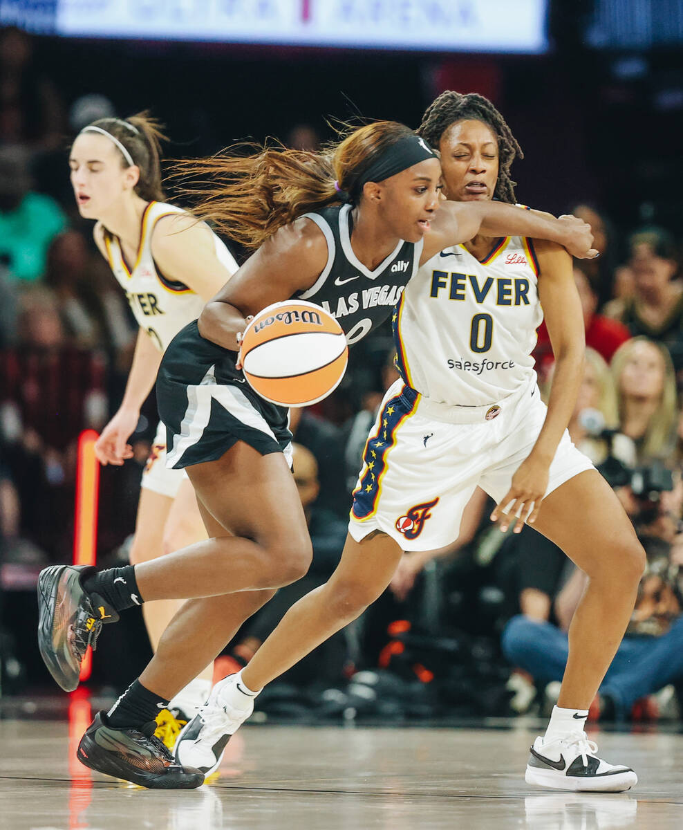 Aces guard Jackie Young (0) drives past Indiana Fever guard Kelsey Mitchell (0) during a game b ...