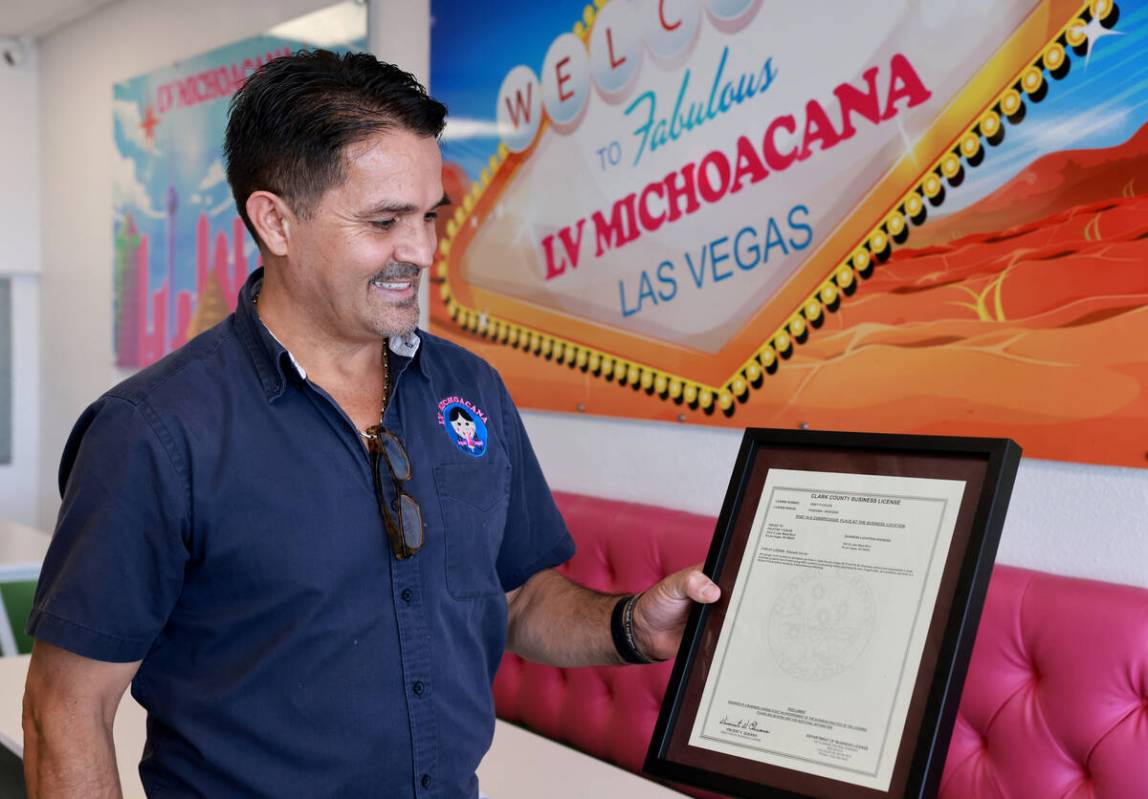 José Manuel Carrera shows the first Clark County sidewalk vendor license during an interview a ...