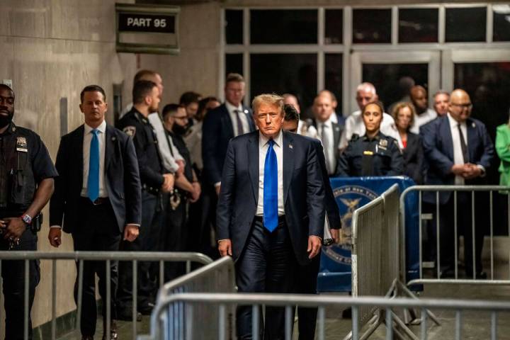 Former President Donald Trump walks out of court and toward the media following the verdict in ...