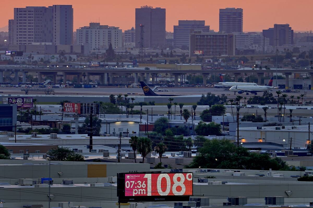 The unofficial temperature hits 108 degrees at dusk at Sky Harbor International Airport in Phoe ...