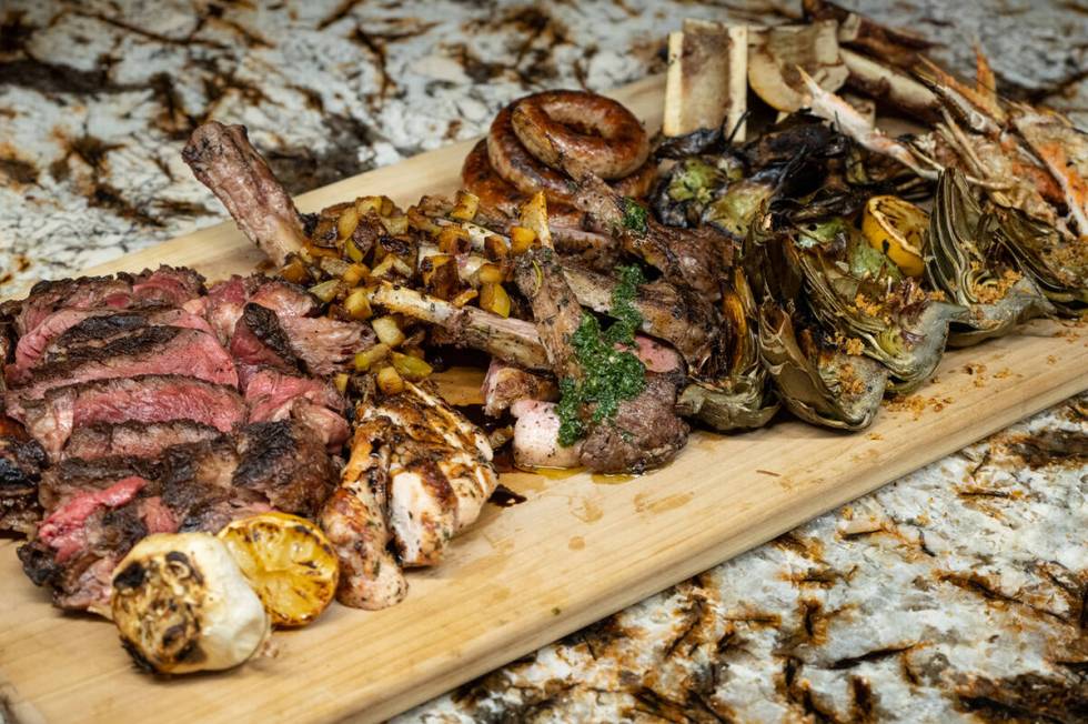 A shareable mixed grill with ribeye, sausage, lamb chops, bone marrow and lemon leaves from Mon ...
