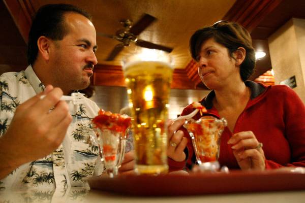 RJ FILE*** JOHN LOCHER/REVIEW-JOURNAL Eddie and Norma Alvarado eat shrimp cocktail at the Gol ...