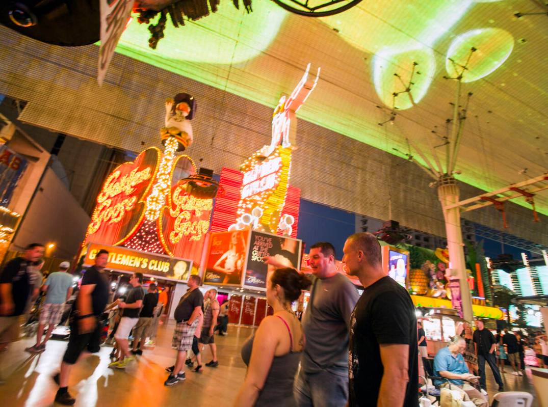 People walk by the Girls of Glitter Gulch, 20 Fremont St., on Tuesday, June 21, 2016. Downtown' ...