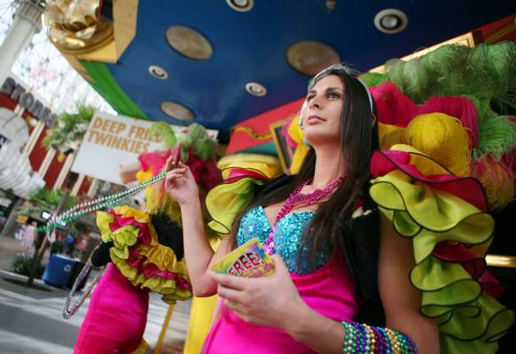 Jenna Furio spins beads to attact customers outside Mermaid's casino at Fremont Street Eperienc ...