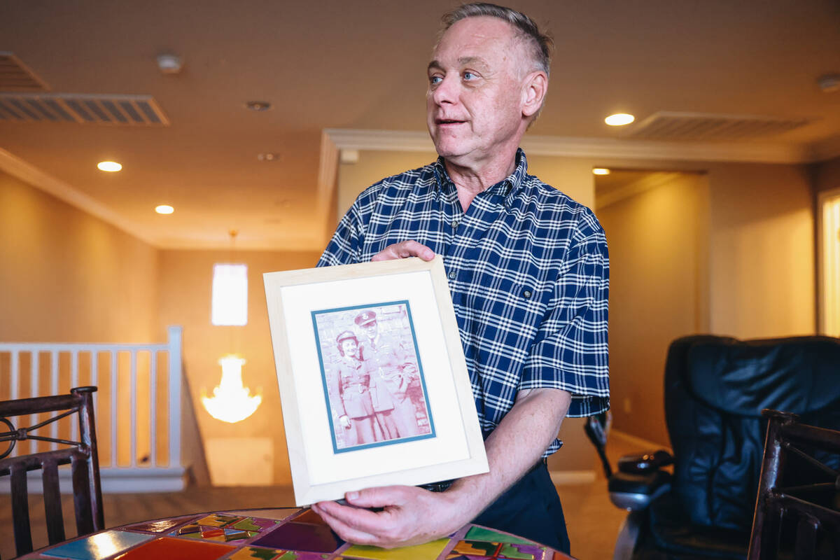 David Gibson holds a photo of his parents Gordon and Marjorie Gibson at his home Thursday, May ...