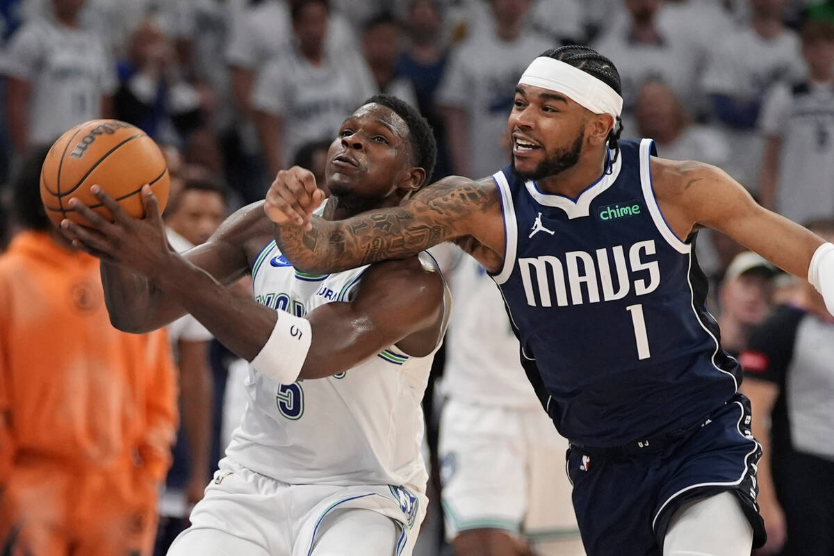 Minnesota Timberwolves guard Anthony Edwards (5) grabs a loose ball in front of Dallas Maverick ...