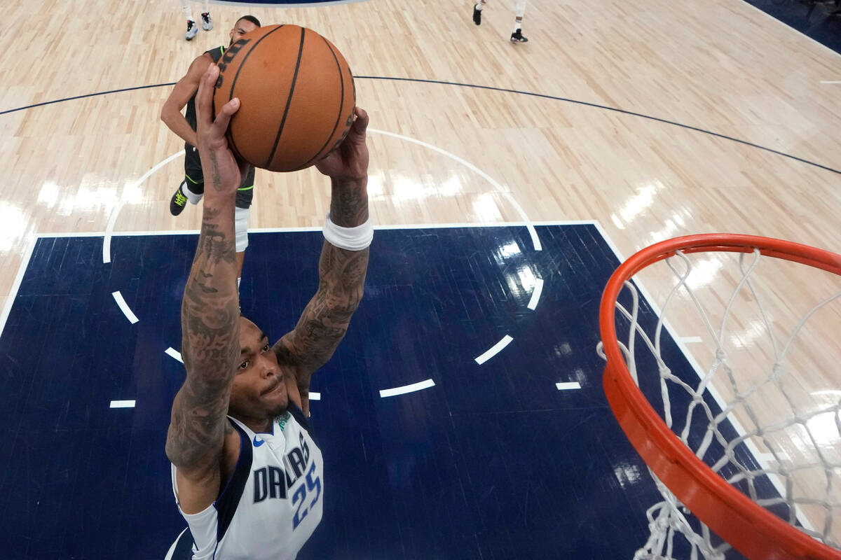 Dallas Mavericks forward P.J. Washington (25) goes up for a dunk against the Minnesota Timberwo ...