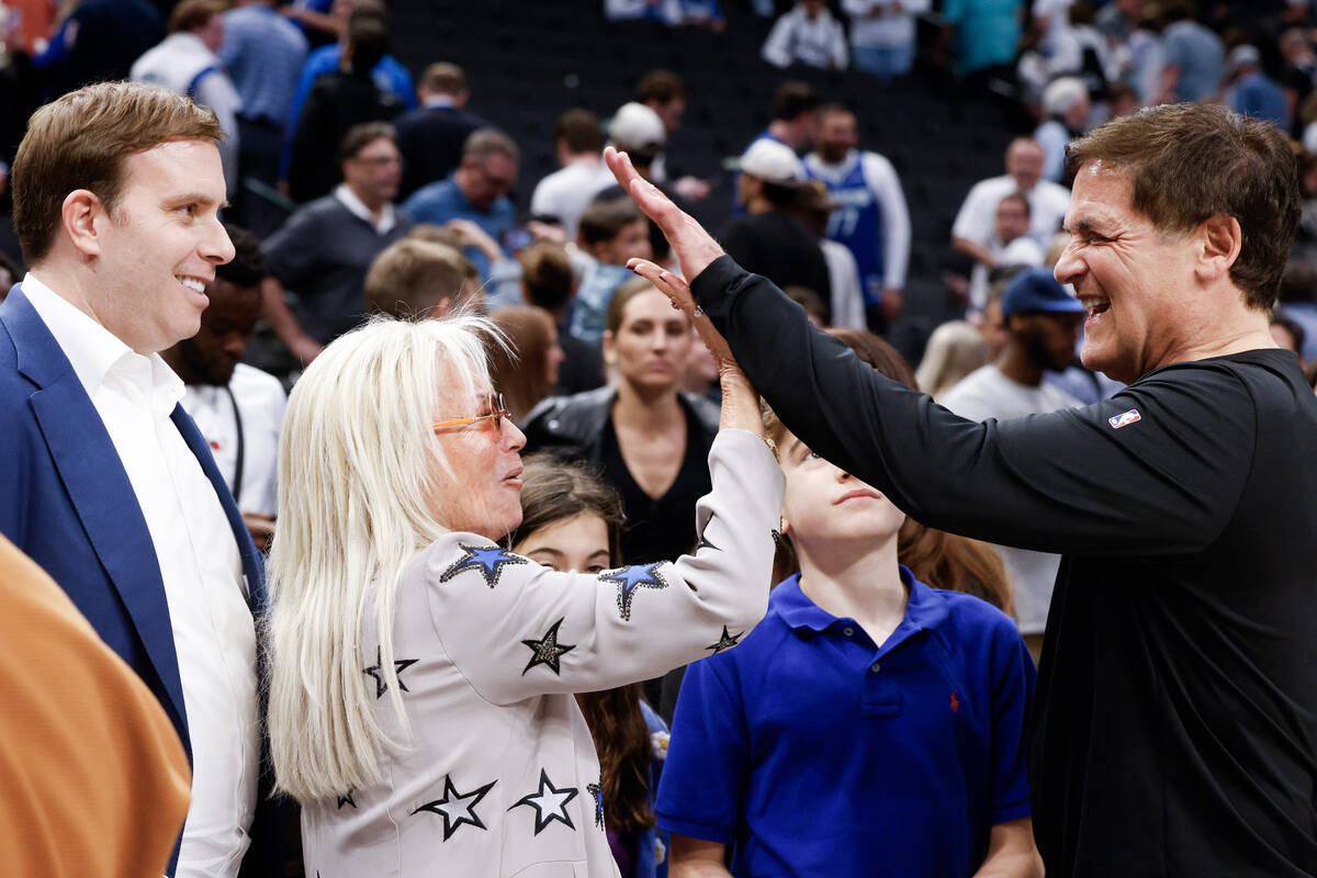 Dallas Mavericks governor Patrick Dumont (left) watches Miriam Adelson (center) high-five Dalla ...