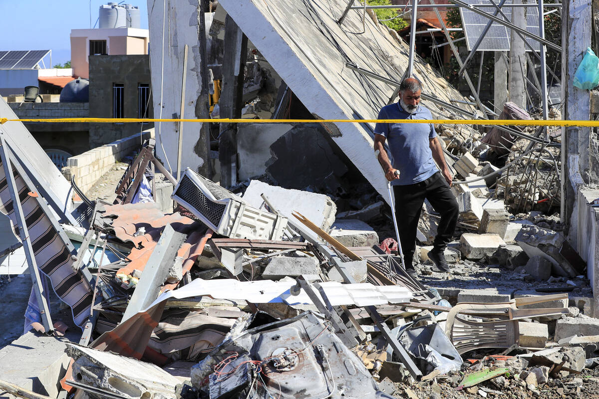 A Lebanese man inspects a destroyed house that was hit on Friday night by an Israeli airstrike, ...