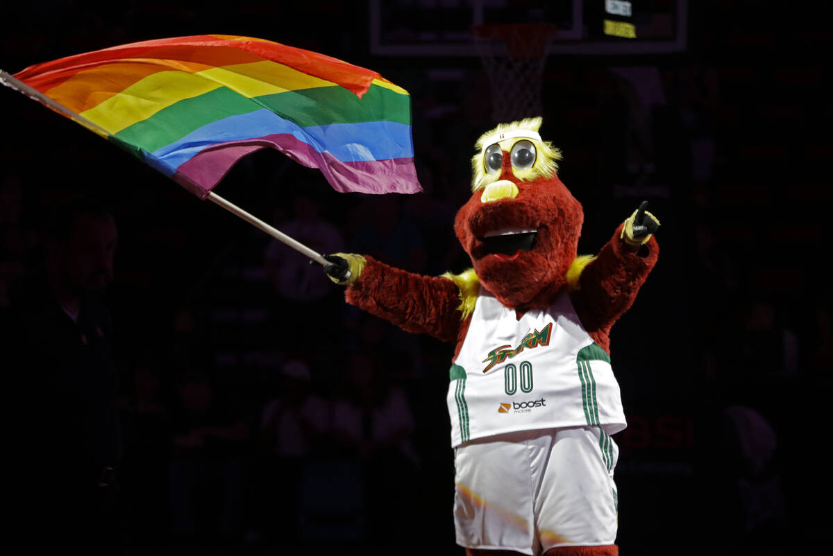 In this June 25, 2015, file photo, Seattle Storm's mascot Doppler holds a rainbow gay pride fla ...