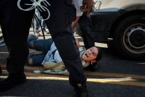 A pro-Palestinian demonstrator yells as a New York City police officer detains her during a pro ...