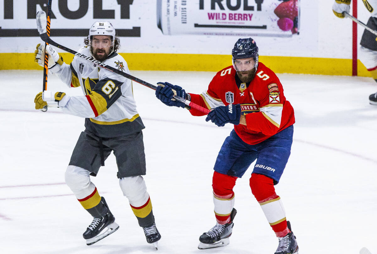 Golden Knights right wing Mark Stone (61) takes a stick from Florida Panthers defenseman Aaron ...