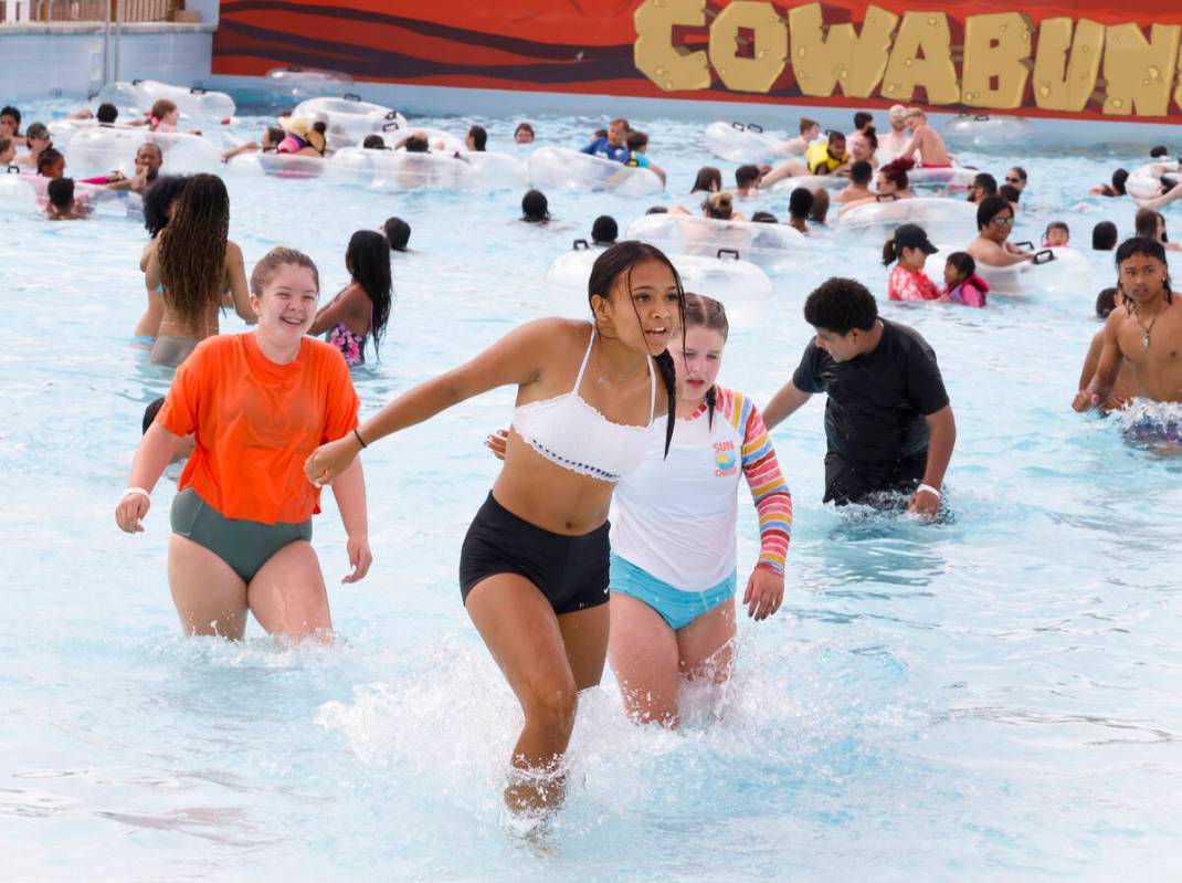 Parkgoers, including Maya Wilcox, 14, center, play at Cadillac Shore Wave pool at Cowabunga Can ...