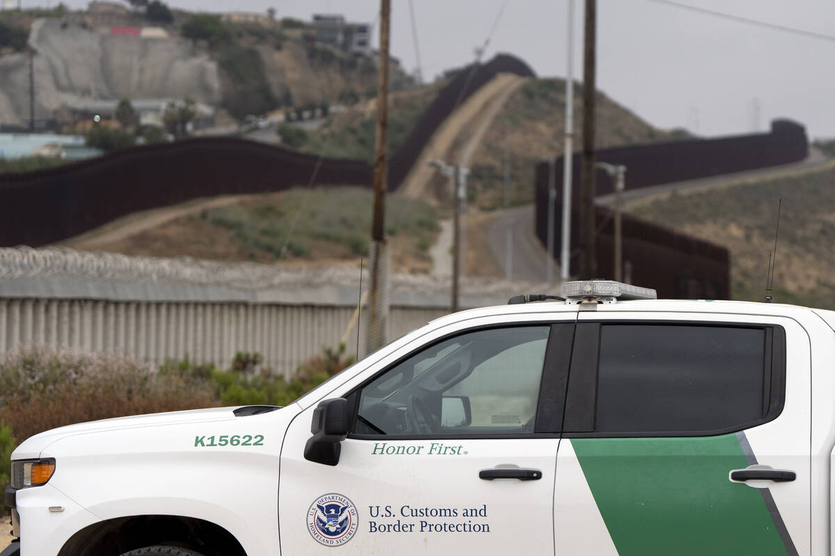 A Border Patrol vehicle sits near border walls separating Tijuana, Mexico, from the United Stat ...